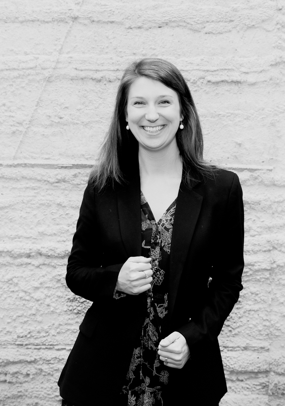 Image of a woman standing smiling facing the camera.